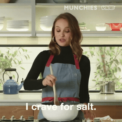 Woman In Apron Stirring Bowl Craving Salt GIF