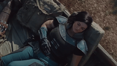 Woman In Armor Lying On Bed GIF