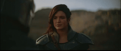Woman In Armor Standing Next To Man In Helmet GIF