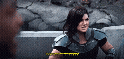 Woman In Armor Talking To Man With Question Mark GIF