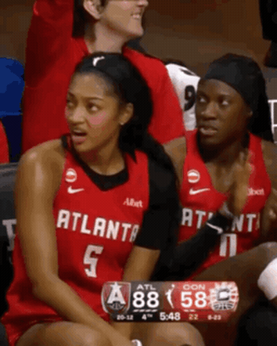 Woman In Atlanta Jersey Sits On Bench GIF
