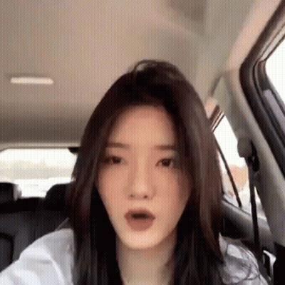 Woman In Back Seat Of Car Making Funny Face GIF