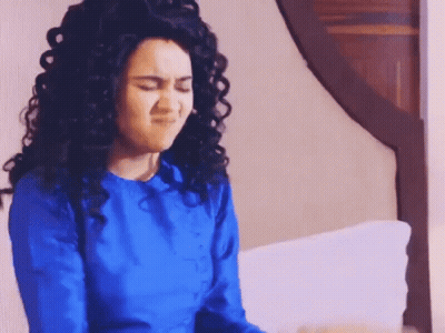 Woman In Bandana And Purse Standing In Bedroom GIF