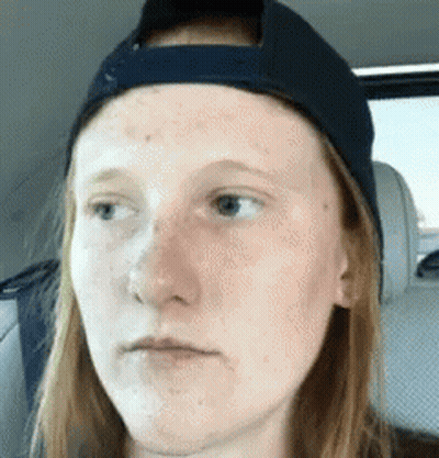 Woman In Baseball Cap Making Funny Face In Back Seat GIF