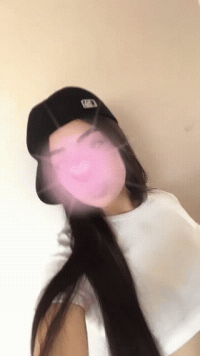 Woman In Baseball Cap Taking Selfie With Pink Heart GIF