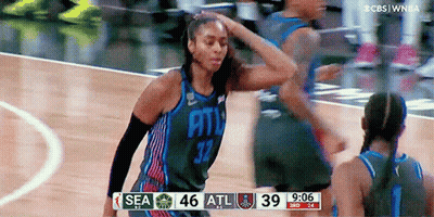 Woman In Basketball Uniform Holding Hair GIF