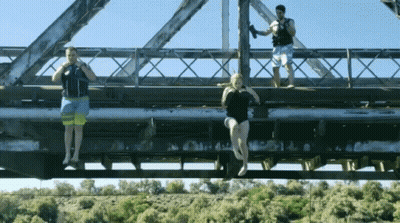Woman In Bathing Suit Hanging From Bridge GIF