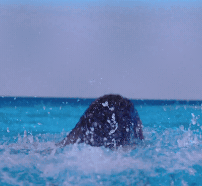 Woman In Bathing Suit In Pool With Necklace GIF