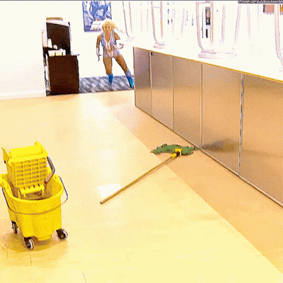 Woman In Bathing Suit Mopping Floor With Yellow Mop GIF
