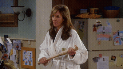 Woman In Bathrobe Holding Baseball Bat GIF