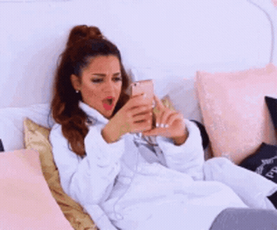 Woman In Bathrobe Lying On Bed GIF