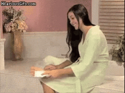 Woman In Bathrobe Sitting On Bathtub Holding Hilariousgifs.com Paper GIF