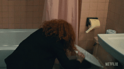 Woman In Bathroom With Netflix Logo GIF