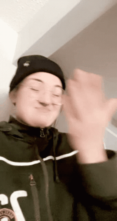 Woman In Beanie And Glasses Clapping GIF