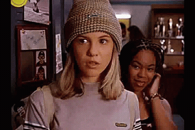 Woman In Beanie And Striped Shirt Beside Another Woman GIF