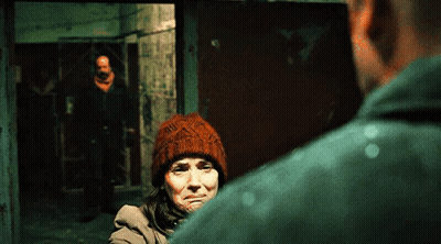 Woman in Beanie Looking at Man in Green Shirt