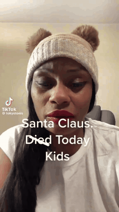 Woman In Beanie Says Santa Died GIF