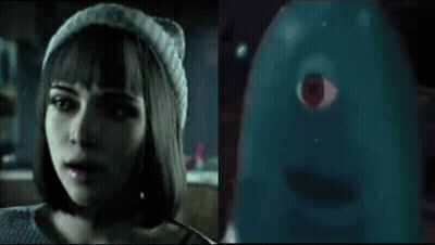 Woman In Beanie Talking To Blue Ghost With Red Eye GIF