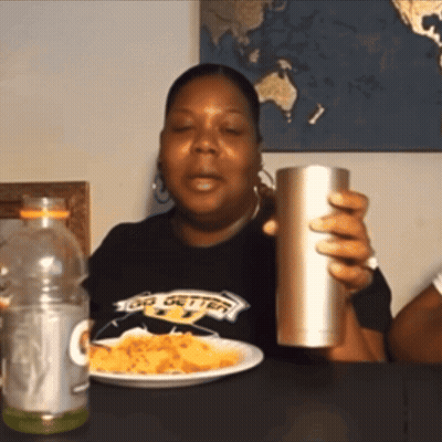 Woman In Big Getter Shirt Holding Cup And Plate GIF