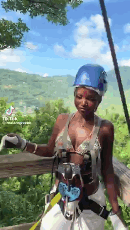 Woman In Bikini And Hard Hat On Ropes Course In Jungle GIF