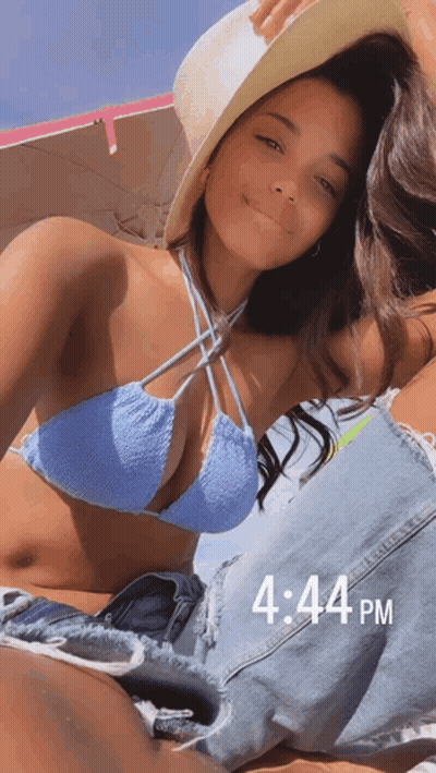 Woman In Bikini And Hat Laying On Beach 4:44 PM GIF
