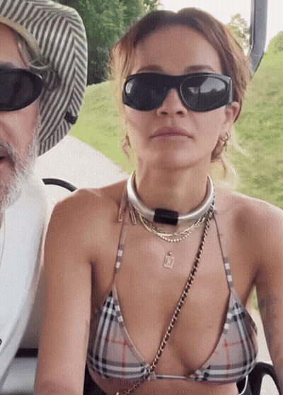 Woman In Bikini And Sunglasses Sitting Next To Man GIF