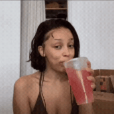 Woman In Bikini Drinking Red Drink From Cup GIF