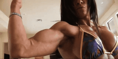 Woman In Bikini Flexing Muscles In Gym GIF