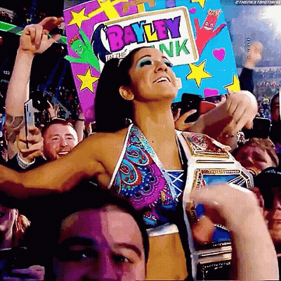 Woman In Bikini Holding Bayley In The Bank Sign GIF