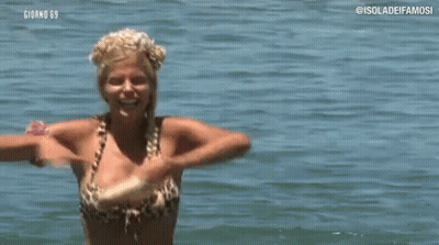 Woman In Bikini Holding Stick In Water GIF