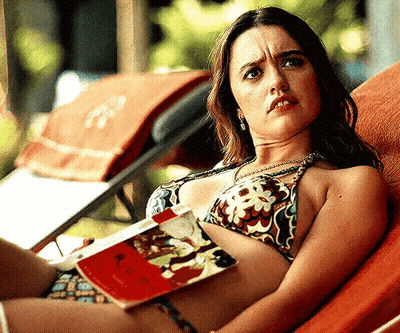 Woman In Bikini Laying On Lounge Chair Reading Book GIF