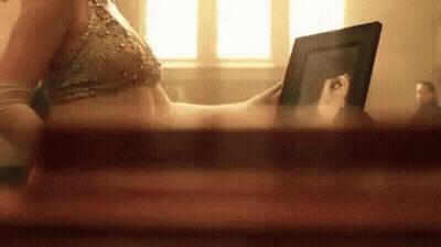 Woman In Bikini Looking At Picture Of Herself GIF