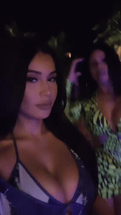 Woman In Bikini Next To Woman In Green Dress GIF