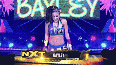 Woman In Bikini Standing In Front Of Bayley Sign GIF