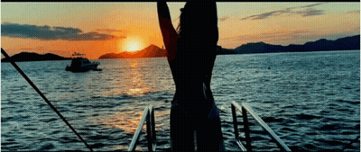 Woman In Bikini Watching Sunset On Boat GIF