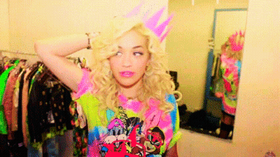 Woman In Birthday Hat In Front Of Dressing Room Mirror GIF