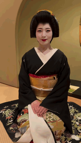 Woman In Black And Gold Kimono Sitting On Rug GIF