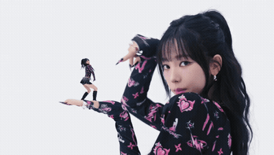 Woman In Black And Pink Floral Shirt Holding Doll GIF