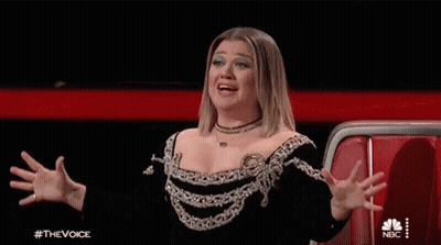 Woman In Black And Silver Dress With Hands In Air GIF