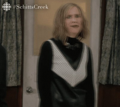 Woman In Black And White Dress At Schitt's Creek Door GIF