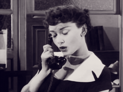 Woman In Black And White Photo Talking On Phone GIF