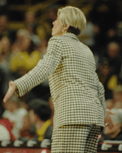 Woman In Black And White Plaid Jacket In Front Of Crowd GIF