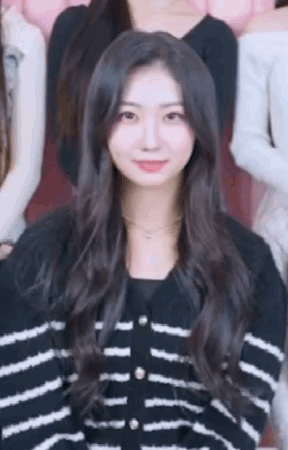 Woman In Black And White Striped Sweater Standing In Group GIF
