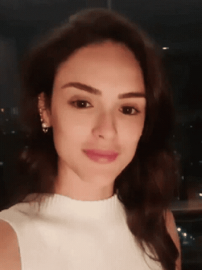 Woman In Black And White Top Holding Hair With Red Lipstick GIF