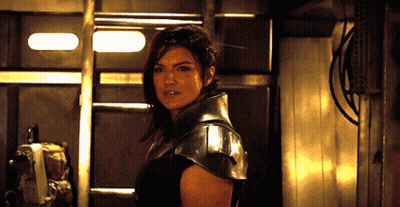 Woman In Black Armor Standing In Room GIF