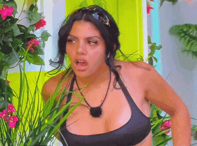 Woman In Black Bikini Top In Flower Garden GIF