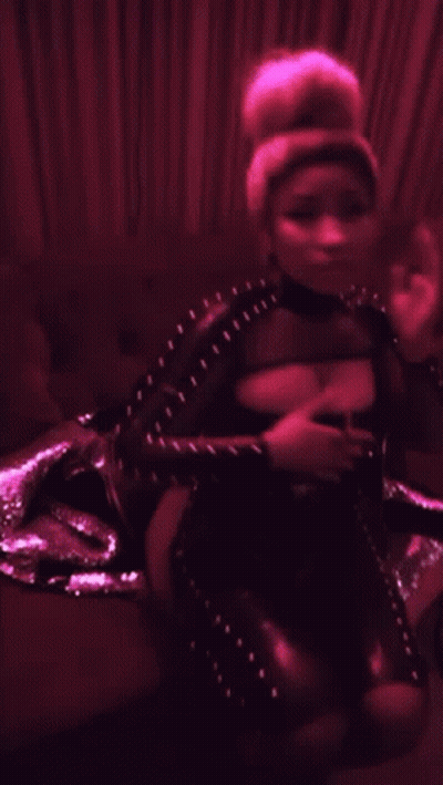 Woman In Black Bodysuit Sitting On Couch In Dark Room GIF