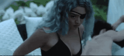 Woman In Black Bra And Eye Patch Laying On Bed Next To Man GIF