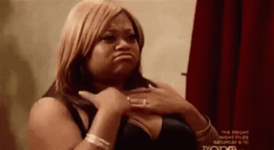 Woman In Black Bra Making Funny Face Hands On Chest GIF