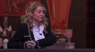 Woman In Black Cardigan With Folded Hands GIF